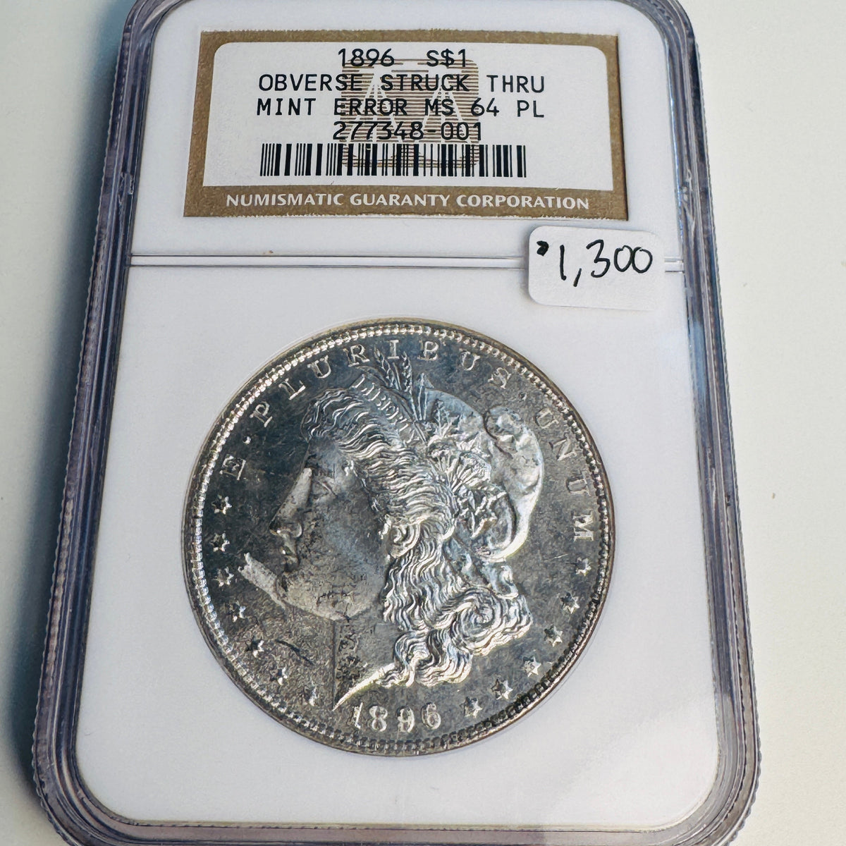 1896 (P) Mint Error Morgan Silver Dollar, Obverse Struck Thru (Debris), NGC MS-64 PL